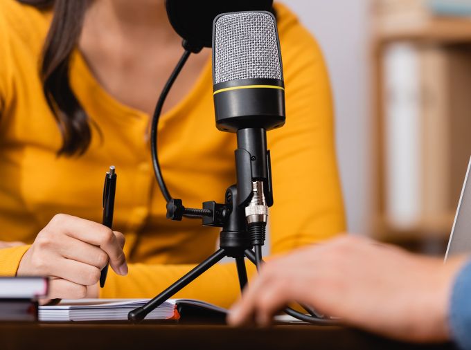 Two people participating in a podcast.