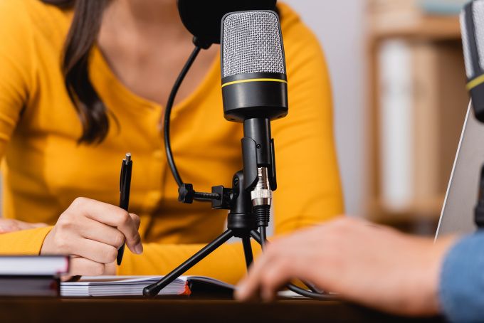 Two people participating in a podcast.