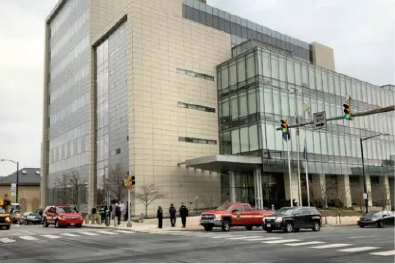 Modern office building, approximately 8 stories at a city intersection.